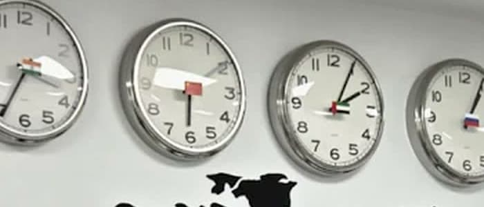 The row of world clocks above the office map