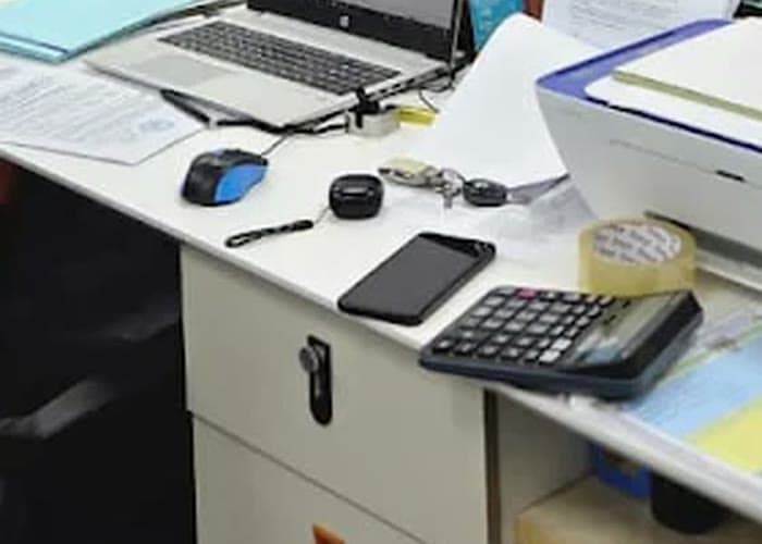 A laptop, a calculator and a set of working papers