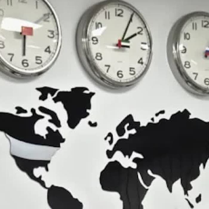 The clocks and the world map above the waiting area
