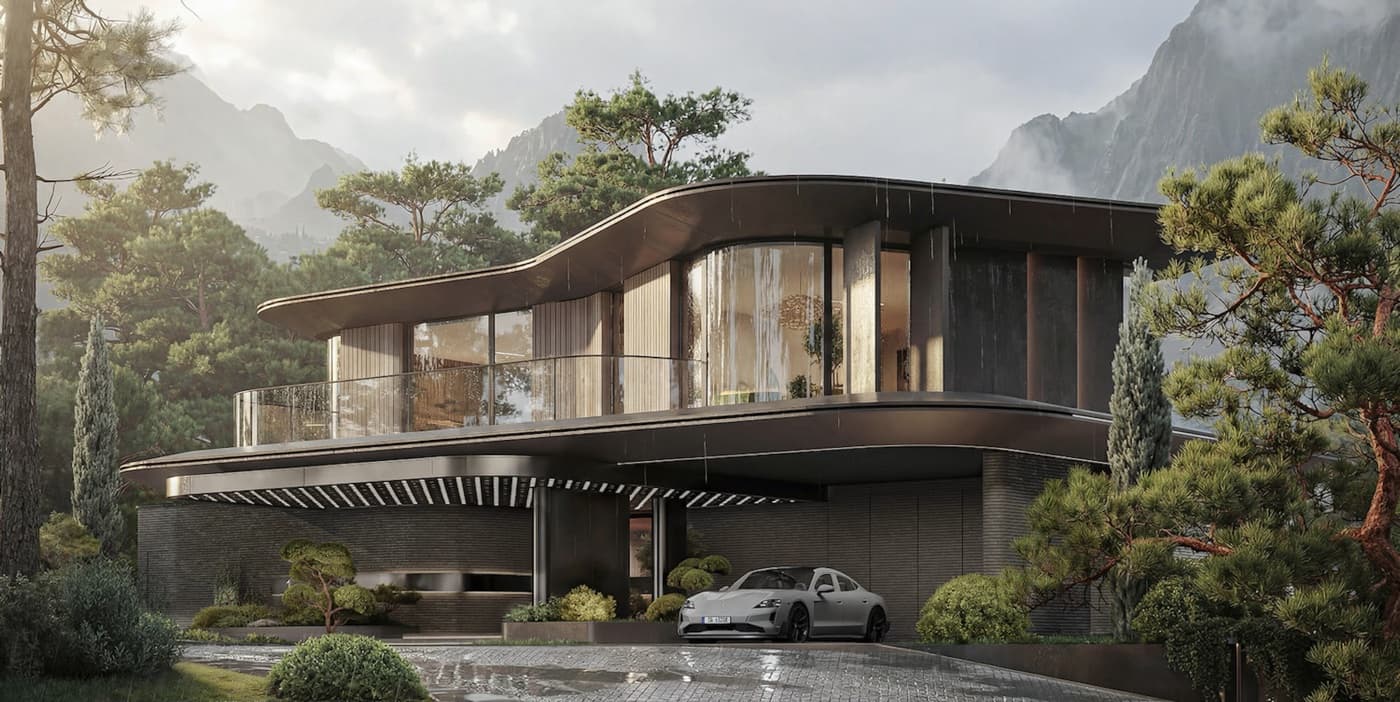 A modern house with a curved roof against a wooded mountainside