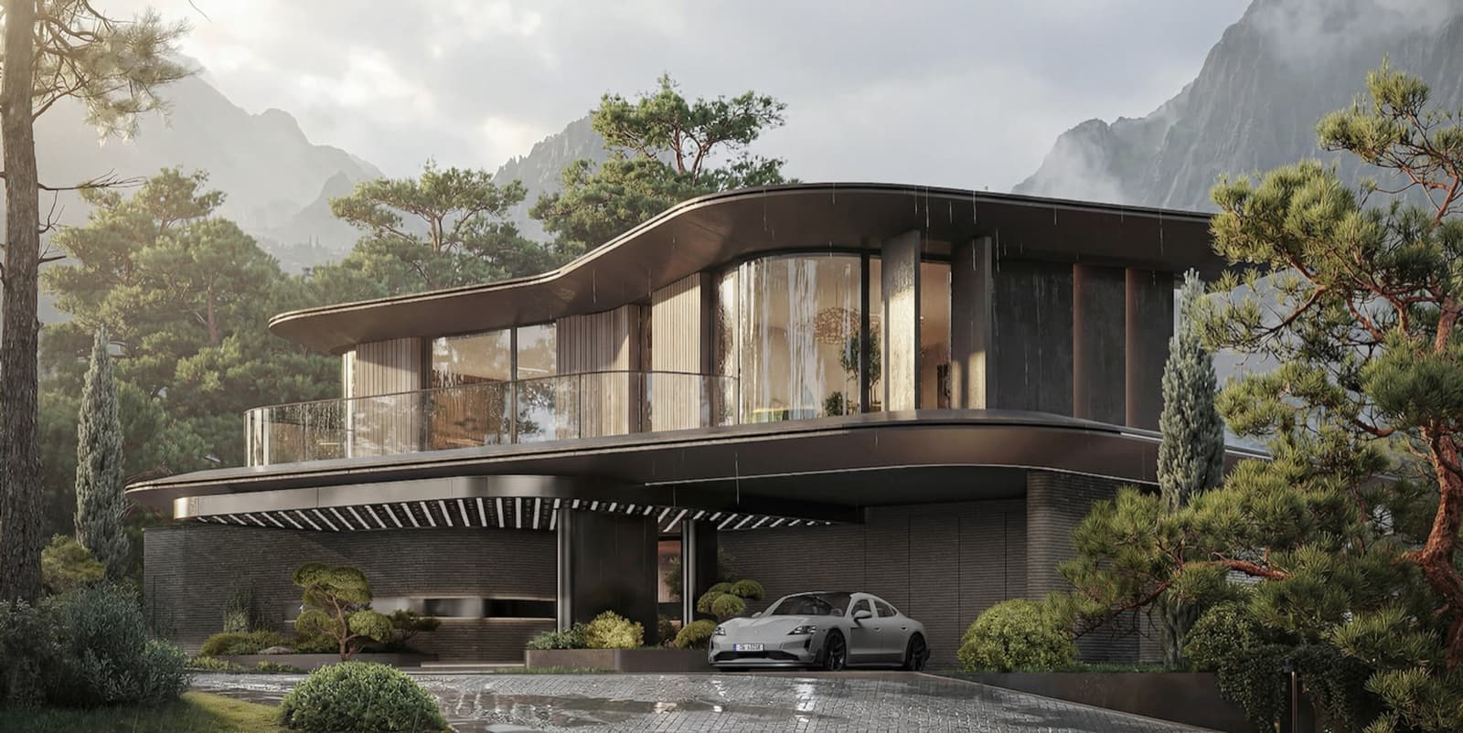 A modern house with a curved roof against a wooded mountainside