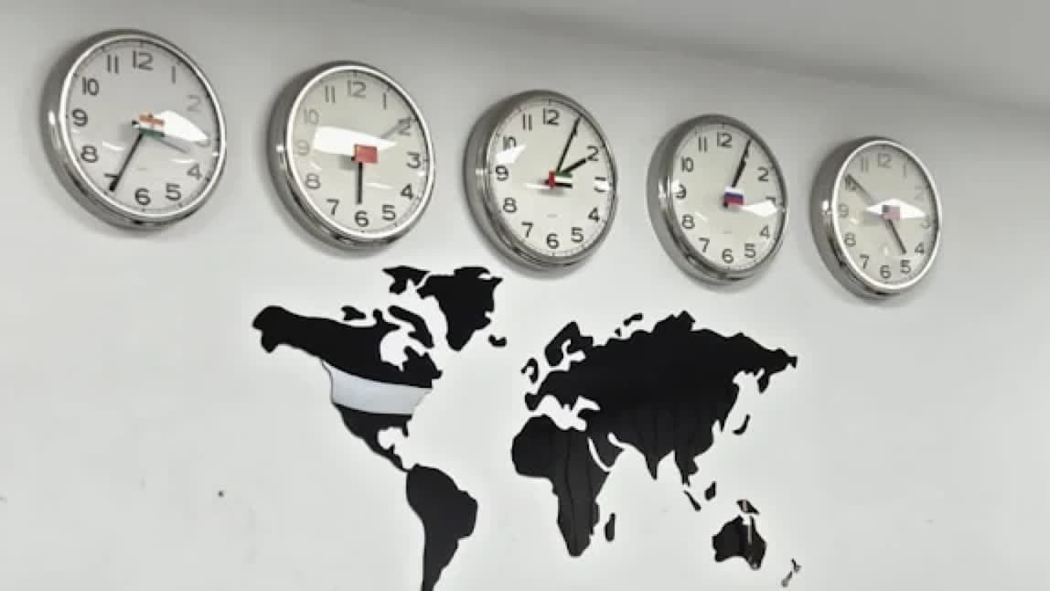 World clocks and a world map on the wall of the MHBC Finance office