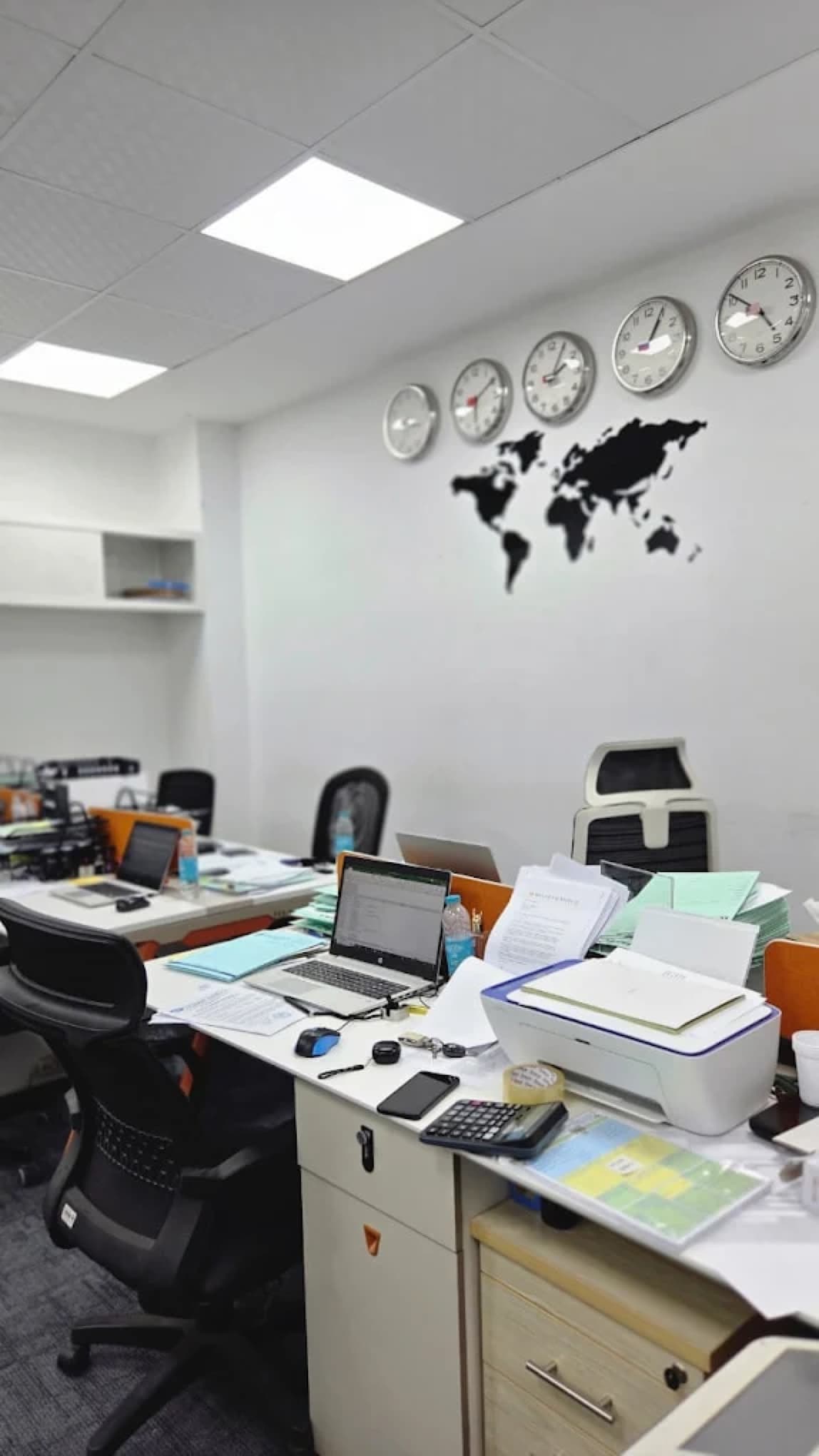 The MHBC Finance office in Dubai, world clocks and a world map above the floor