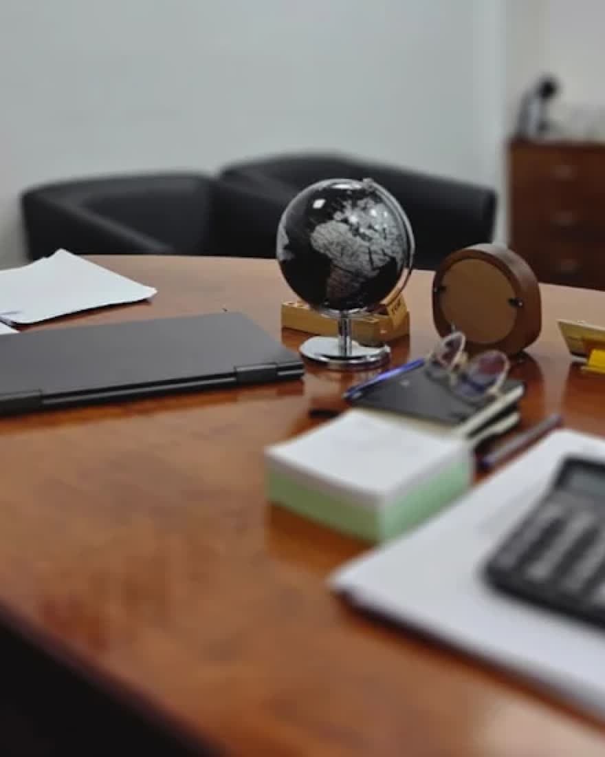A desk globe and paperwork on the boardroom table at MHBC Finance