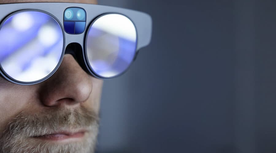 A close-up of augmented-reality glasses with data reflected in the lenses.