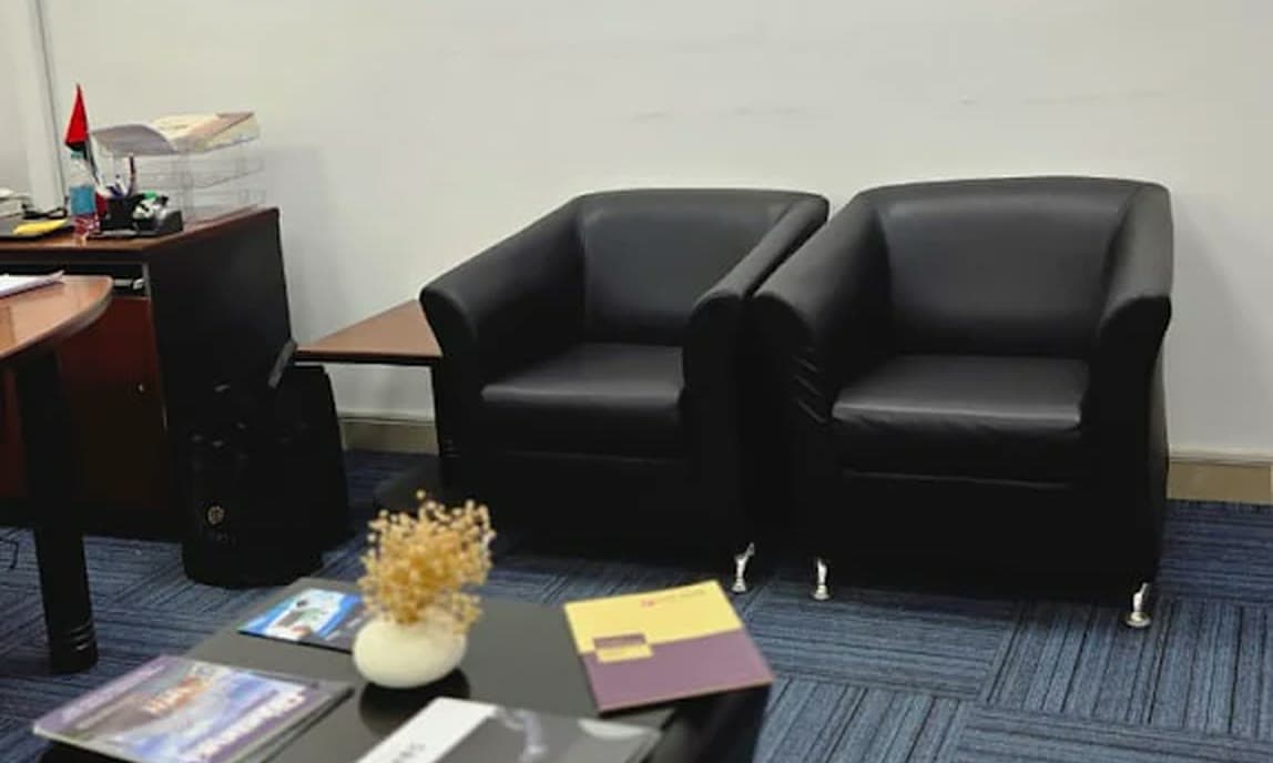 Reception seating below the MHBC wall sign in the office.